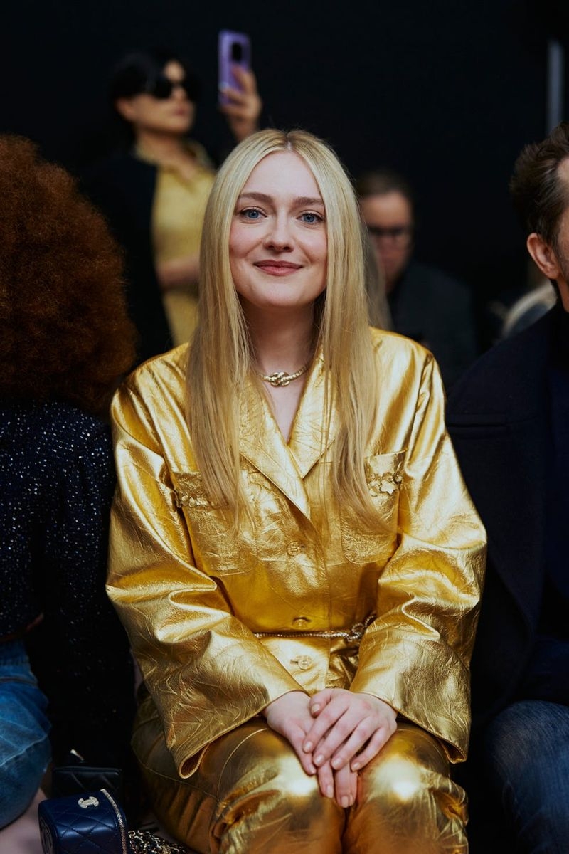 woman sitting in a gold suit
